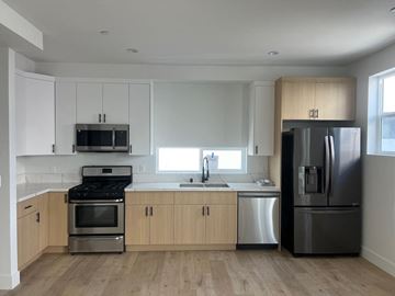 North Hollywood apartment for rent - a kitchen with white cabinets and stainless steel appliances