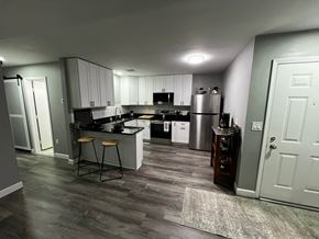 Trenton apartment for rent - A kitchen with a black counter top and white cabinets.