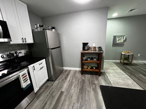 Trenton apartment for rent - A kitchen with a black stove top oven and a black refrigerator.