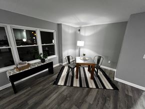 Trenton apartment for rent - A living room with a black and white striped rug, a wooden coffee table, and a lamp.