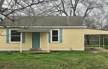 San Antonio house for rent - a yellow house with a blue door in a field