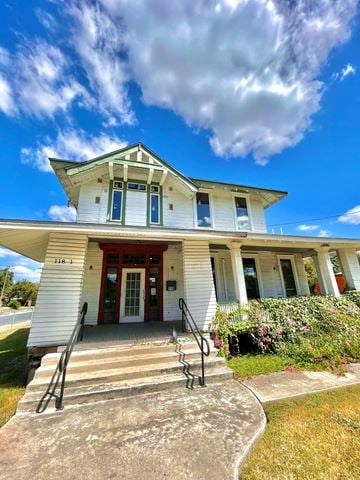 San Antonio house for rent - A white house with a red door and windows.
