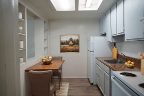 St. Augustine apartment for rent - A kitchen with a table and chairs and a painting on the wall.