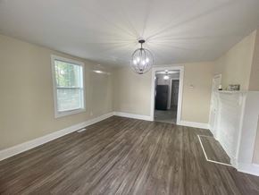 Anderson house for rent - a newly renovated living room with a hard wood floor and a chandelier