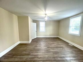 Anderson house for rent - an empty living room with wood flooring and a window