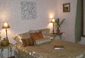 Titusville apartment for rent - A bedroom with a bed, two lamps, and a plant.