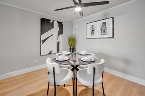 Jacksonville apartment for rent - A dining room with a table set for two and two chairs.