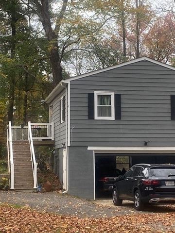 Huntington house for rent - a gray house with a car parked in a garage