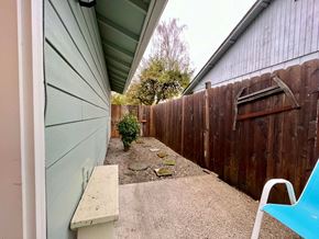 Longview house for rent - a backyard with a green garage door and a wooden fence