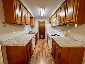 Longview house for rent - a kitchen with wood flooring and granite counter tops