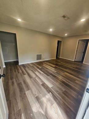 St. Louis house for rent - A room with wooden flooring and white walls.
