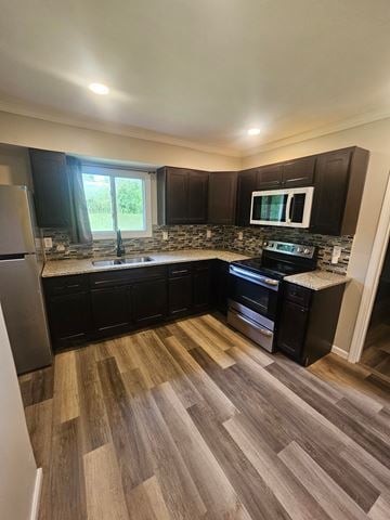 St. Louis house for rent - A kitchen with black cabinets and a wooden floor.