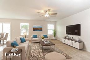 Charlotte house for rent - A living room with a couch, chairs, and a television.