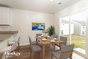 Charlotte house for rent - A dining room with a wooden table and grey chairs.