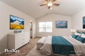 Charlotte house for rent - A bedroom with a bed, dresser, and ceiling fan.