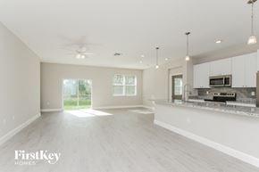 Palm Bay house for rent - a spacious kitchen and living room with white cabinets and a counter top