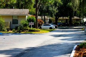 Brandon apartment for rent - A white car is parked on the side of a street.