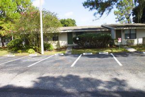 Brandon apartment for rent - A parking lot with a building in the background.