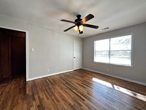Conroe apartment for rent - an empty living room with a ceiling fan and a window