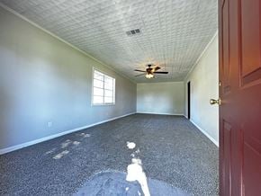 Conroe apartment for rent - an empty room with a ceiling fan and a door