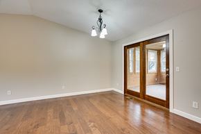 Eagan house for rent - an empty living room with a wooden floor and an open door to a bedroom