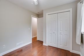 Eagan house for rent - an empty room with white closets and a hard wood floor