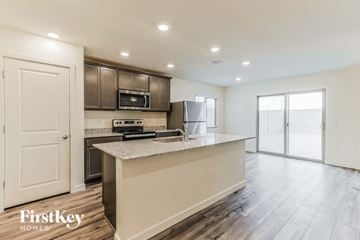 Florence house for rent - a kitchen with an island and a stainless steel refrigerator