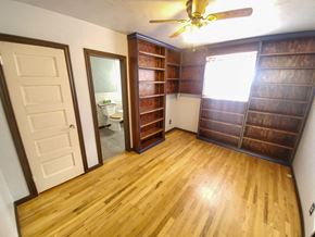 Trinidad house for rent - A room with a wooden floor and a ceiling fan.