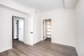 Van Nuys apartment for rent - a bedroom with white walls and a closet and wood flooring