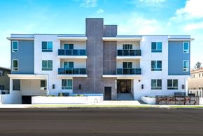 Van Nuys apartment for rent - a white and blue building with a street in front of it
