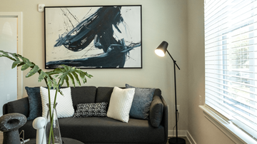 Charlotte apartment for rent - a living room with a couch and a painting on the wall