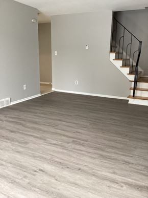 Brampton apartment for rent - an empty living room with wood floors and a staircase