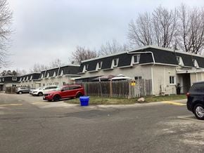 Brampton apartment for rent - a row of houses with roofs and cars parked in a parking lot
