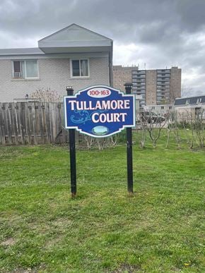 Brampton apartment for rent - a court sign in the grass in front of a house