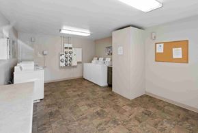 Vancouver apartment for rent - a spacious laundry room with white appliances and a counter with a sink