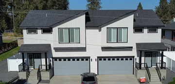 Spokane apartment for rent - a white house with a car parked in front of it