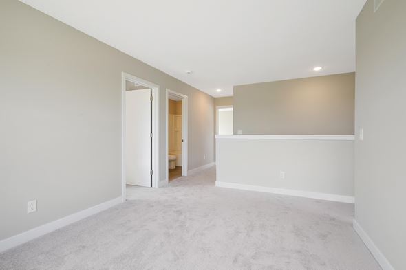 Hudson house for rent - a spacious living room with white carpet and a white wall