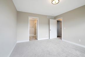 Hudson house for rent - a bedroom with a carpeted floor and a door to a hallway