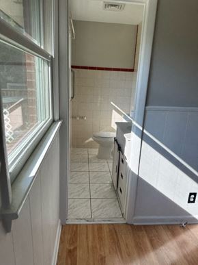 Fayetteville house for rent - A bathroom with a toilet and a window.