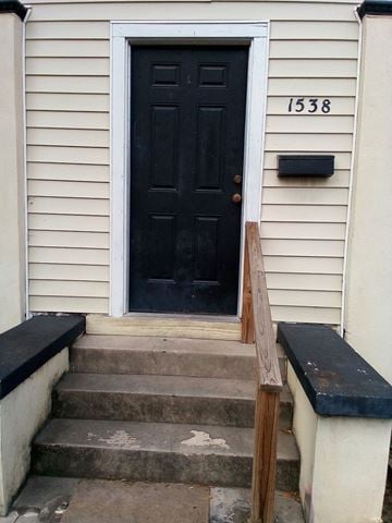 Jacksonville house for rent - a house with a black door and stairs in front of it