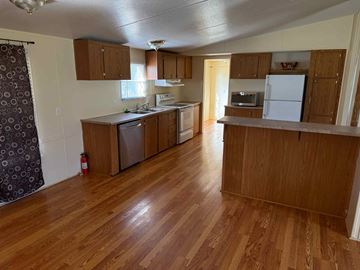 Georgetown house for rent - an empty kitchen with wood flooring and wooden cabinets