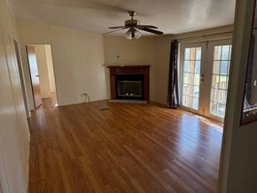 Georgetown house for rent - an empty living room with a wood floor and a fireplace