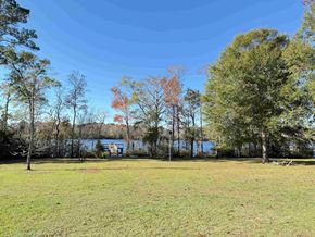 Georgetown house for rent - a grassy field with a lake in the background