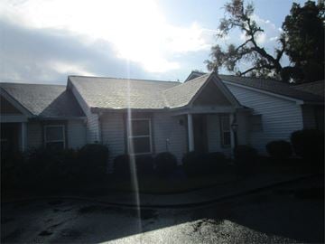 Bainbridge house for rent - a white house with a sun shining on the roof