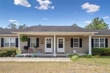 Raeford house for rent - A house with a white door and a sign that says "For Sale".