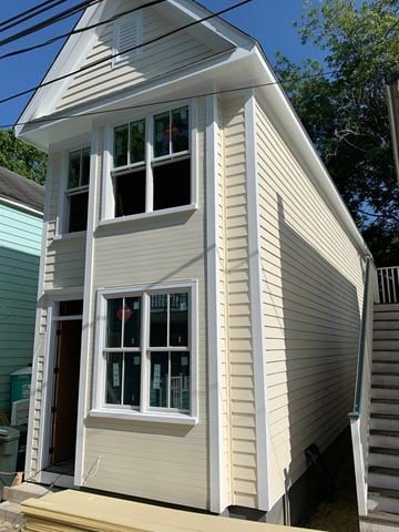 Charleston house for rent - a white house with white siding and white windows