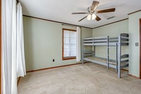 Palm Bay house for rent - a bedroom with bunk beds and a ceiling fan