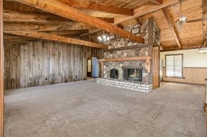 Palm Bay house for rent - the living room of a cabin with a large stone fireplace