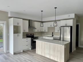 Lantz apartment for rent - A modern kitchen with a large island and stainless steel appliances.