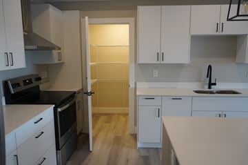 Lantz apartment for rent - A kitchen with white cabinets and a black stove top oven.